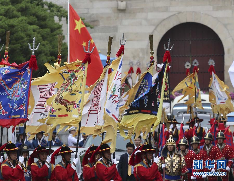 7月3日，韓國(guó)總統(tǒng)樸槿惠在青瓦臺(tái)總統(tǒng)府舉行隆重儀式，歡迎中國(guó)國(guó)家主席習(xí)近平對(duì)韓國(guó)進(jìn)行國(guó)事訪問(wèn)。這是習(xí)近平的車(chē)隊(duì)在身著民族服裝的韓國(guó)禮儀隊(duì)伍引導(dǎo)下駛?cè)肭嗤吲_(tái)。新華社記者丁林?jǐn)z  